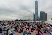 People doing yoga on central harbour front hong kong