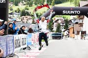 woman jumping for joy at the finish line of a race