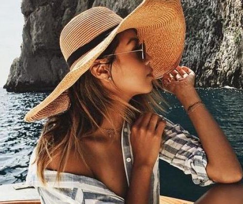 Woman wearing a sunhat on a boat