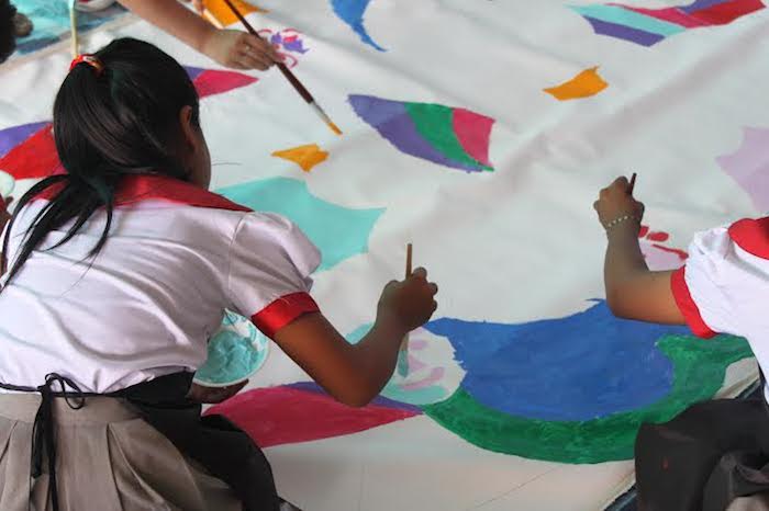 Girl painting with colours at The Sovereign Art Foundation