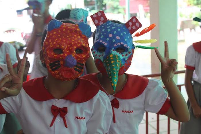 Children wearing masks that they have made at The Sovereign Art Foundation