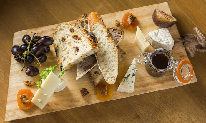 A wooden board with a selection of breads