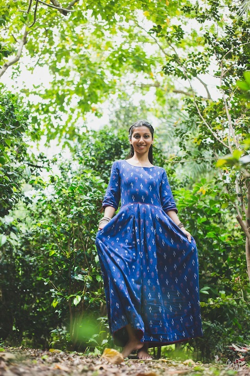 girl standing surrounded by trees in a park