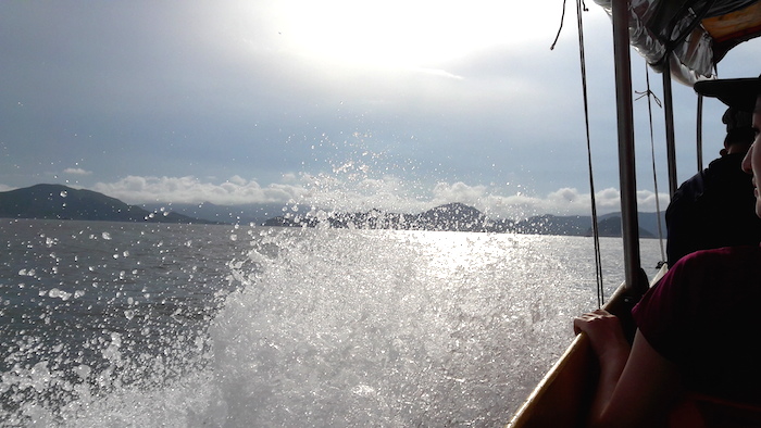 a boat being sprayed with ocean water