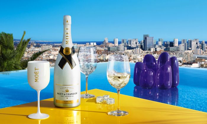 a bottle of moet on a yellow table