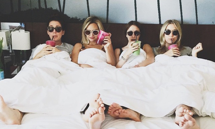 friends in a hotel room wearing sun glasses and drinking smoothies