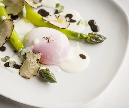 Eggs and asparagus on a white plate