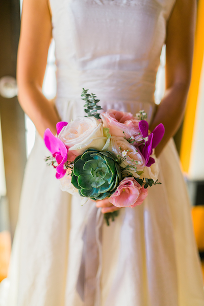 a bride in a wedding gown holding flowers