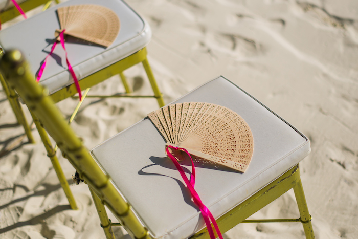 a fan on a bamboo chair