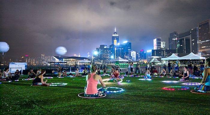 sitting on the grass with a neon hula hoop