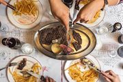 friends eating steak and fries