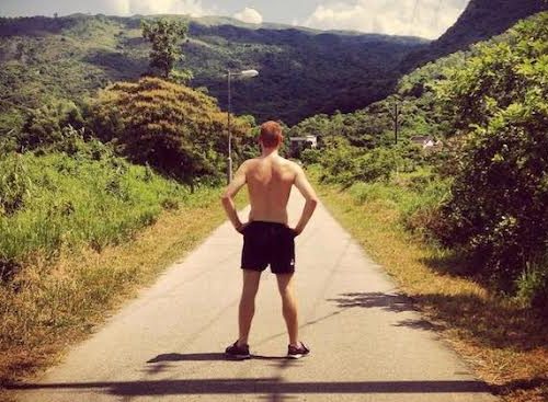 shirtless man standing in the wilderness