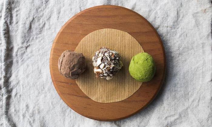 three vegan chocolate balls on a plate