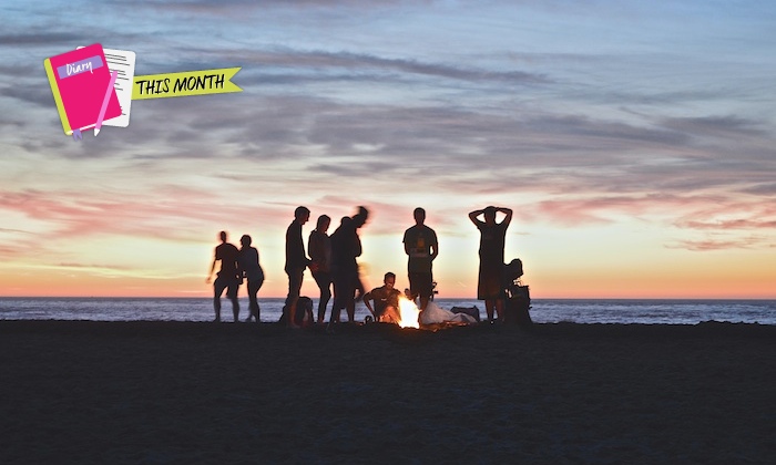 friends on a beach at sunset