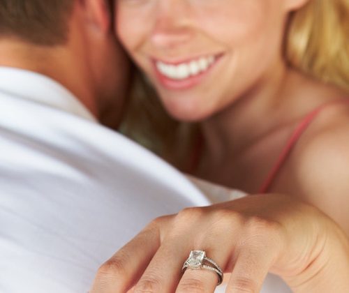 a woman showing off her engagement ring