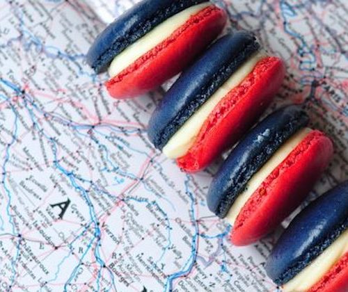 french coloured macaroons on a map