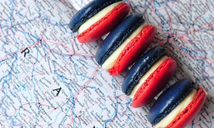 french coloured macaroons on a map