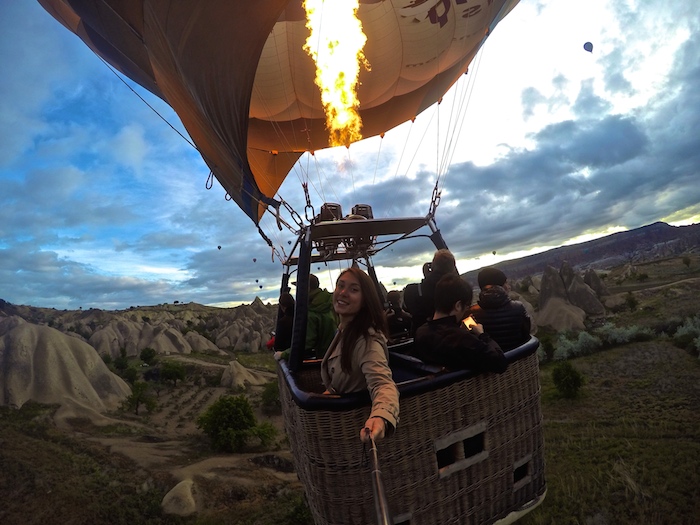 a girl taking a selfie in a hot air balloon in cappadocia turkey