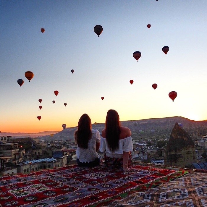 two girls watching the hot air balloons in cappadocia turkey