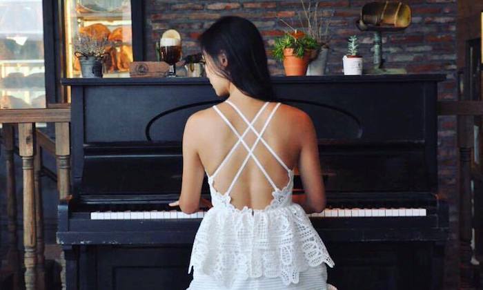 woman playing piano in white dress