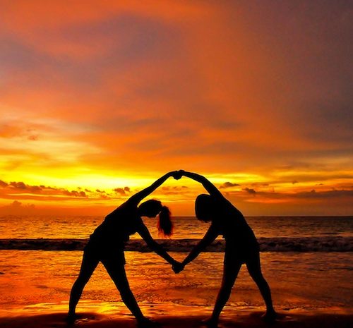 two friends leaning sideways at sunset