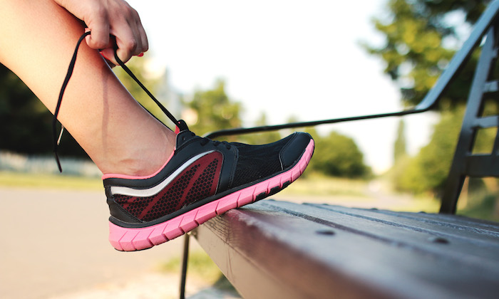 girl tying the laces of her running shoes