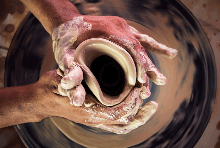 hand shaping pottery