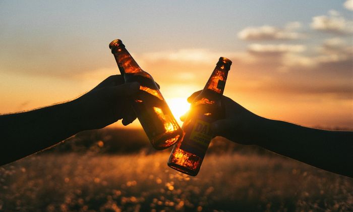 two bottles of beer clinking