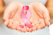 woman holding breast cancer support logo