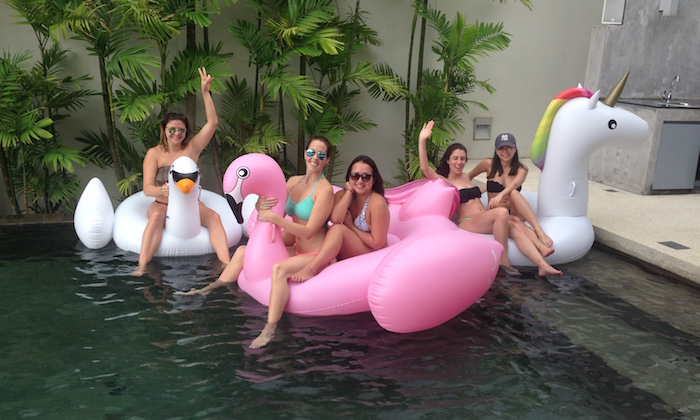 friends floating on a pink swan