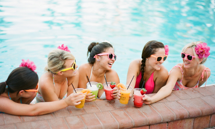 girls drinking cocktails in the pool