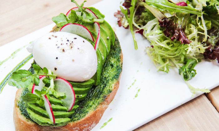 avocado on toast and poached egg at elephant grounds