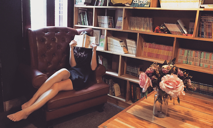 girl reading a book in a big chair