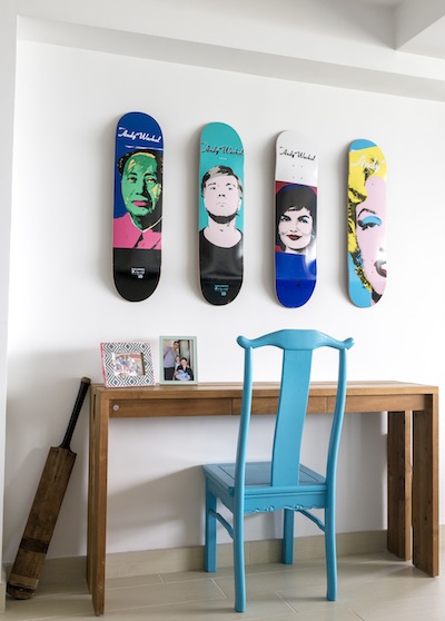 painted skateboards hanging on a wall