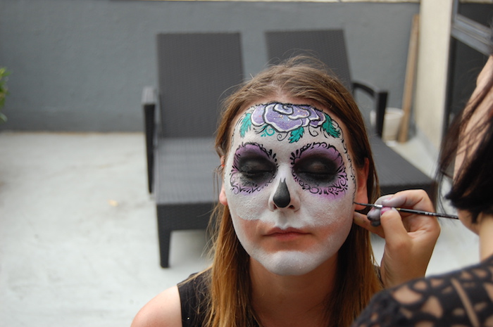 face painting a sugar skull