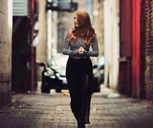 girl standing in an alleyway