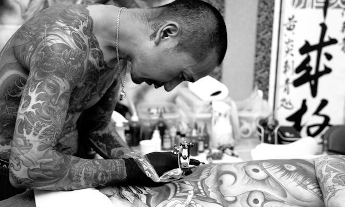 man tattooing 