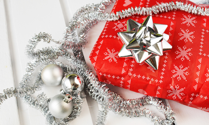 red christmas present and silver tinsel