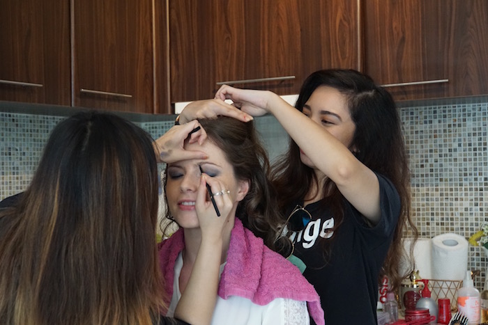 woman having her hair and makeup done