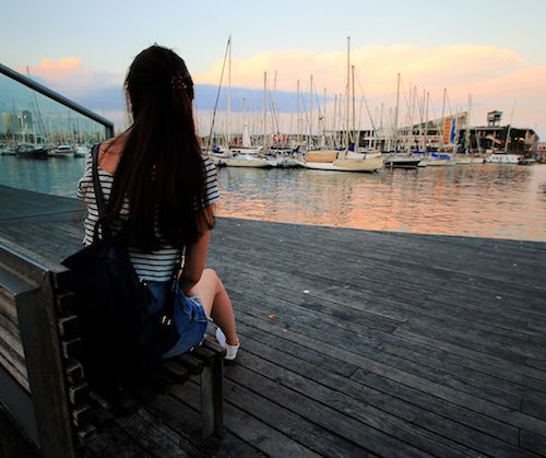 girl sitting by the harbour