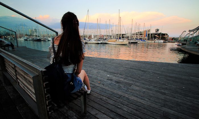 girl sitting by the harbour