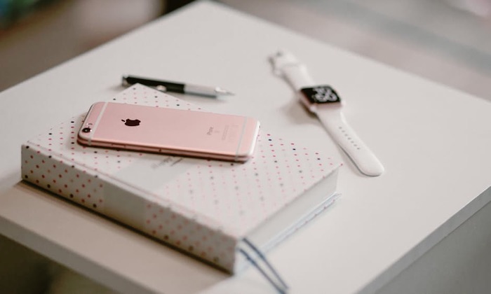pink iphone with book
