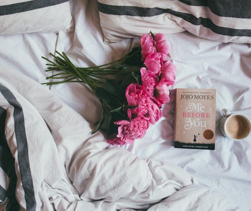 Pink flowers on the bed with a book