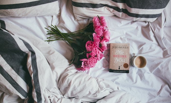 Pink flowers on the bed with a book