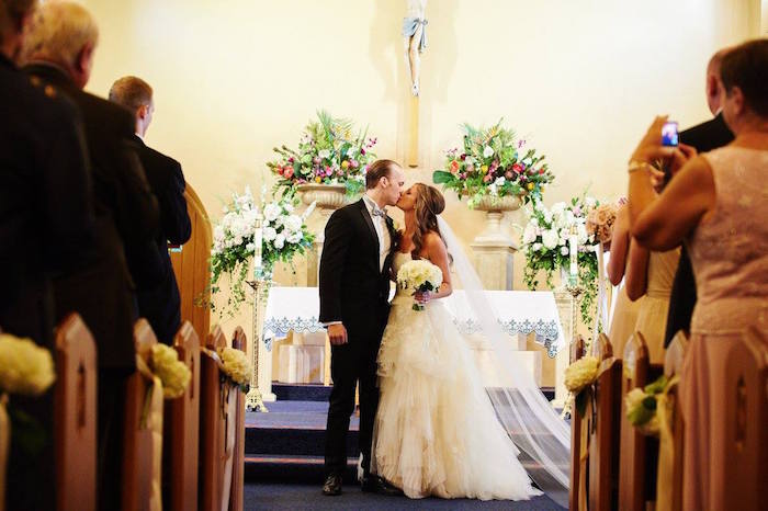 bride and groom at the alter