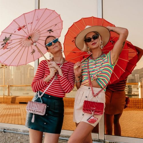 2 women holding umbrellas