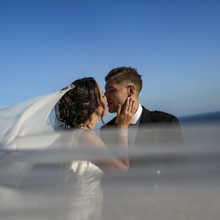 women and men kissing at wedding