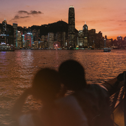 hong kong couple by the skyline on a first date at sunset