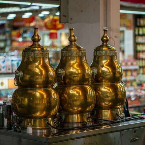 Three traditional Chinese herbal tea containers placed in front of Herbal shop