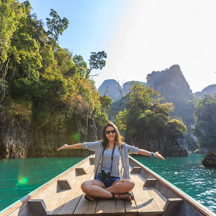 public holidays in 2026 to maximise your annual leave; woman on a boat in Thailand on holiday